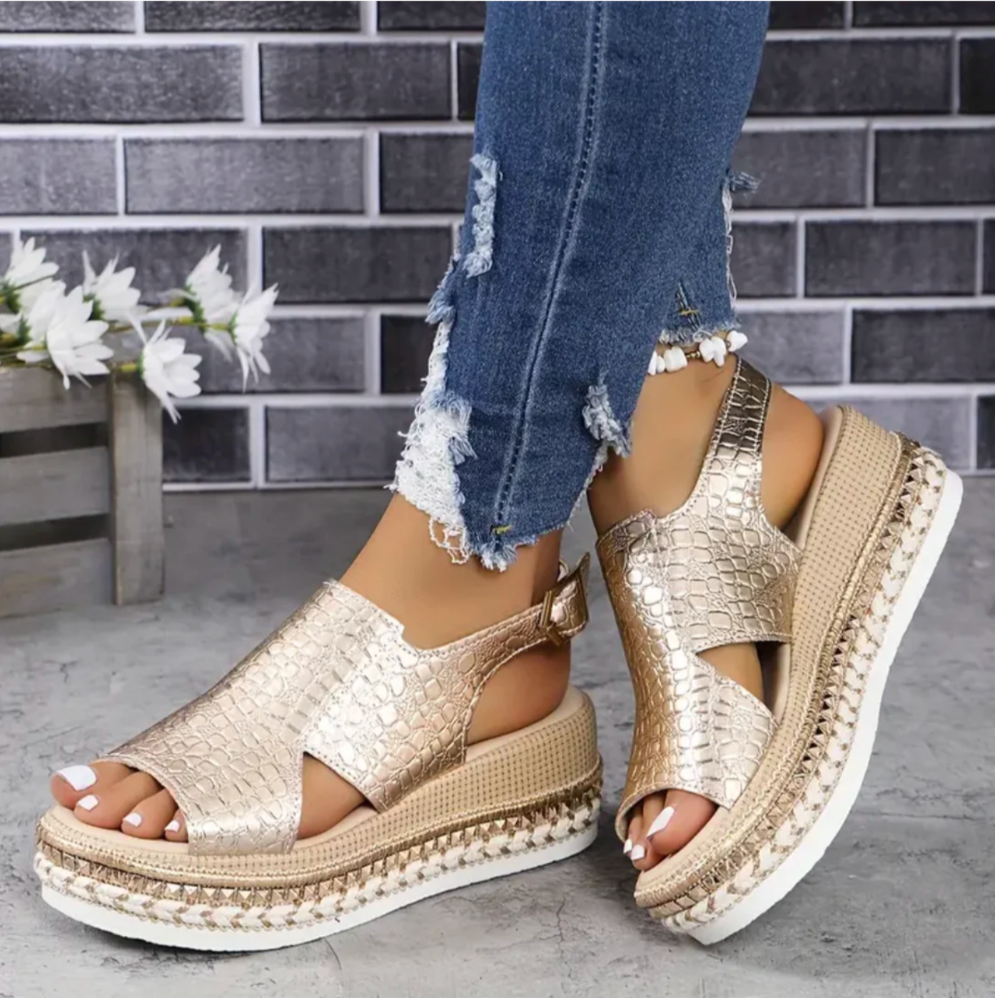 Gold croc-embossed platform sandals with ankle strap and white sole