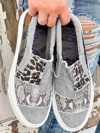 Top view of leopard print canvas slip-on sneakers showing mixed pattern design