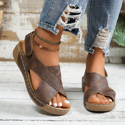 Tan suede wedge sandal styled with distressed denim and beaded ankle accessories