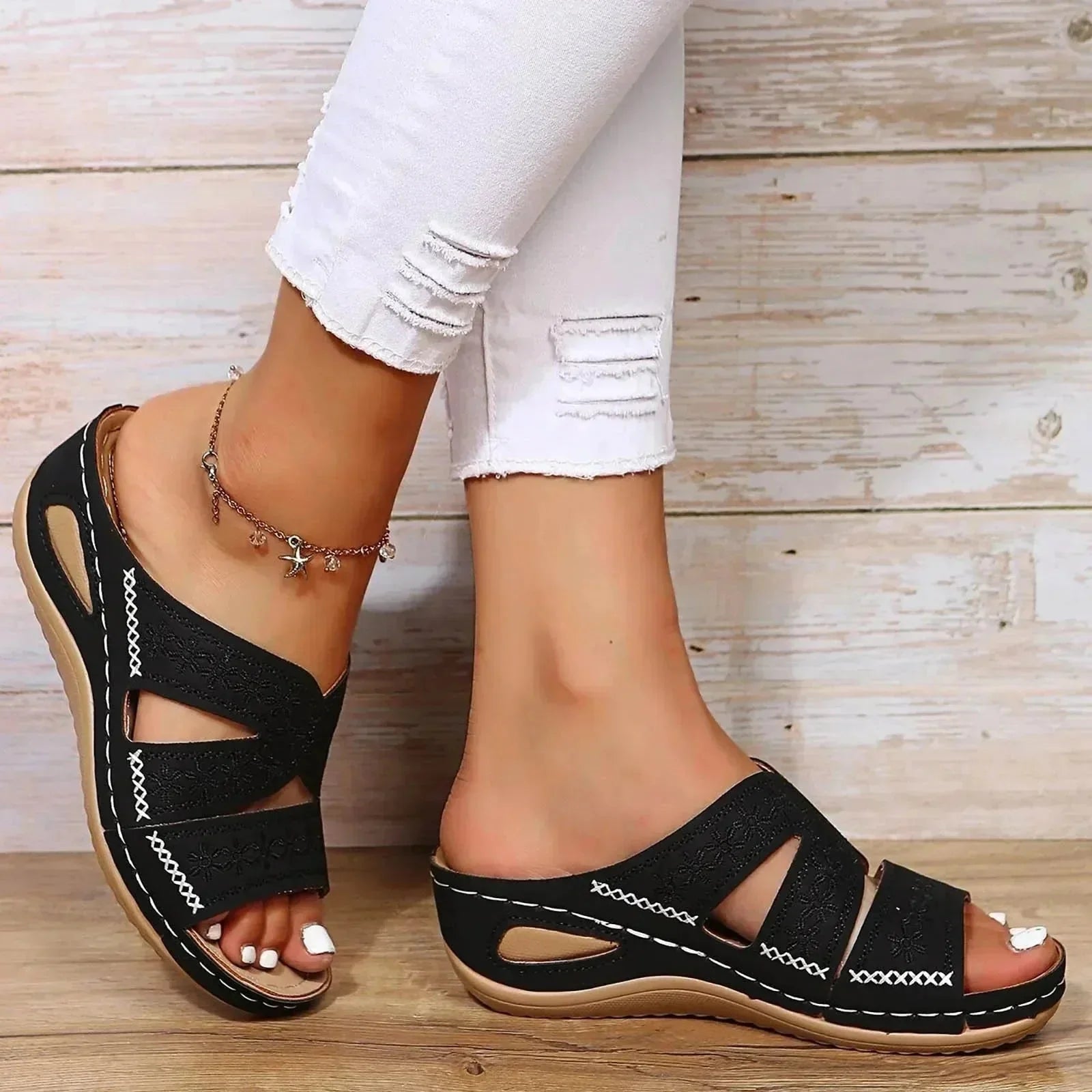 Black adjustable wedge platform slide sandals with embroidered straps and white contrast stitching
