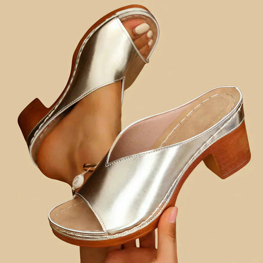 Silver metallic block heel mule sandal with open toe and wooden heel