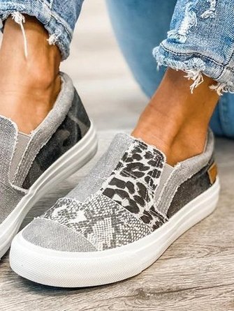 Pair of women's animal print canvas slip-ons showing leopard and snake pattern design