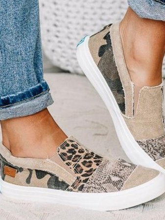 Side profile of women's slip-on sneaker with mixed animal print canvas upper