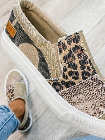 Close-up of canvas slip-on sneaker showing leopard print and snake texture details