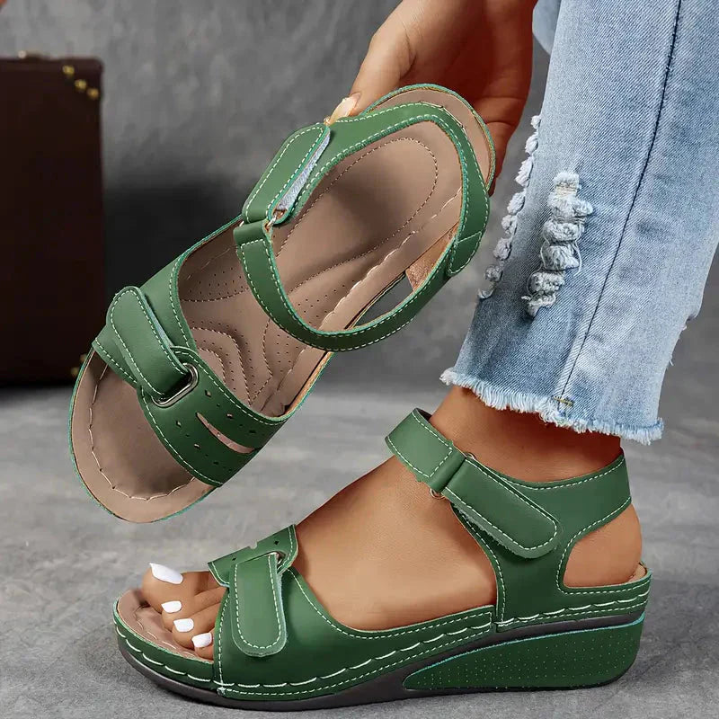 Green adjustable strap platform wedge sandals shown from side with padded insole visible