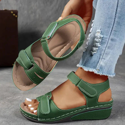 Green adjustable strap platform wedge sandals shown from side with padded insole visible