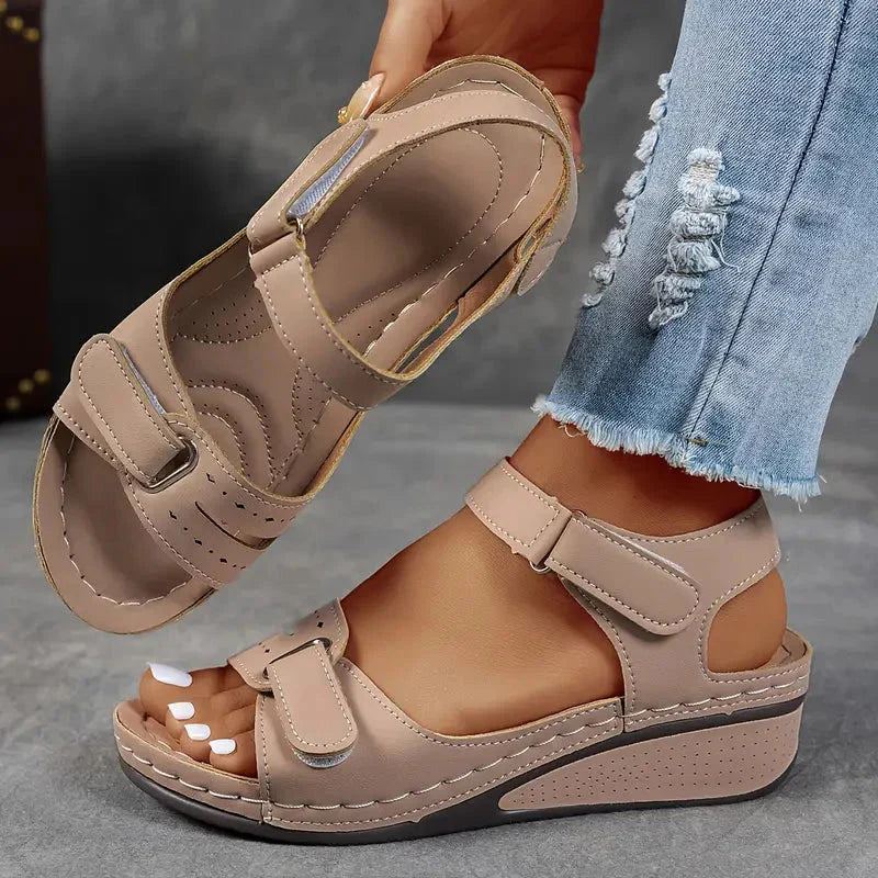 Beige platform wedge sandals with adjustable straps shown from side with quilted insole
