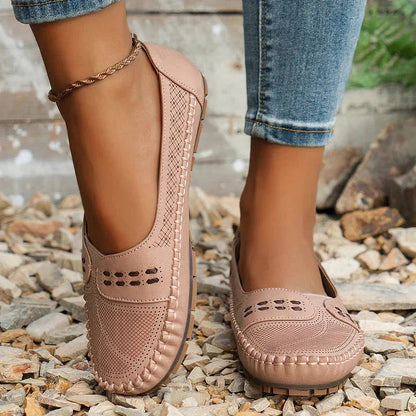 Beige perforated moc toe loafer flat with quilted sole and decorative perforations on upper
