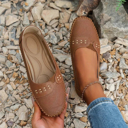 Cognac brown perforated moc toe loafer flat with decorative stud detail