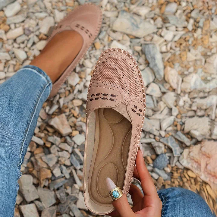 Beige cushioned moc toe loafer flat worn with jeans, side profile view