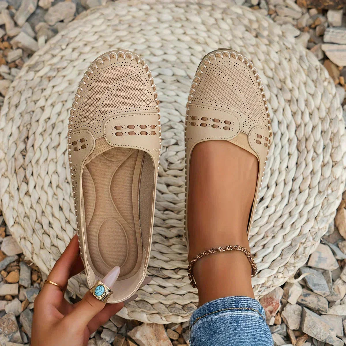 Beige perforated moc toe loafer flats with cushioned insole, shown from top view