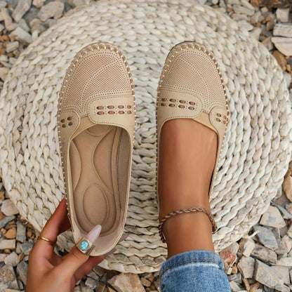 Beige perforated moc toe loafer flats with cushioned insole, shown from top view