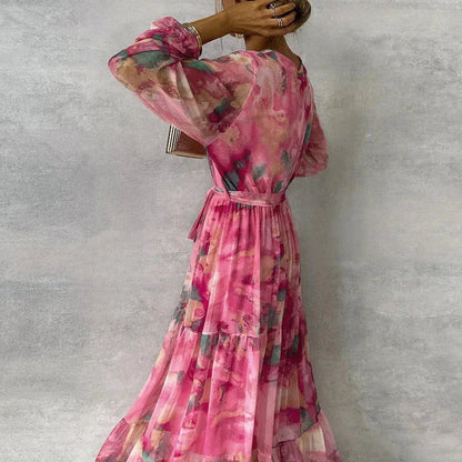Back view of pink floral maxi dress with puffed sleeves and tiered hem
