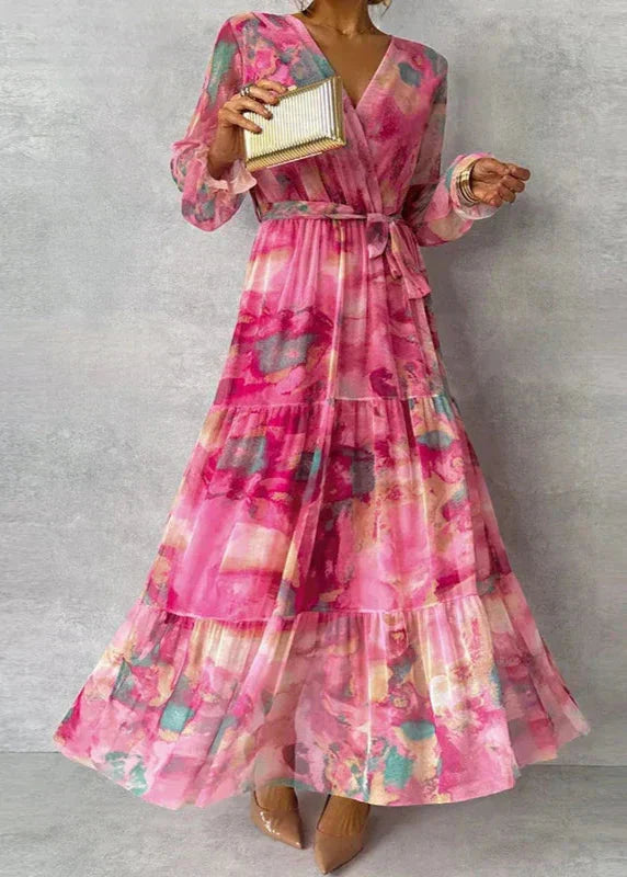 Pink floral maxi dress with v-neck, puffed sleeves, and tiered skirt