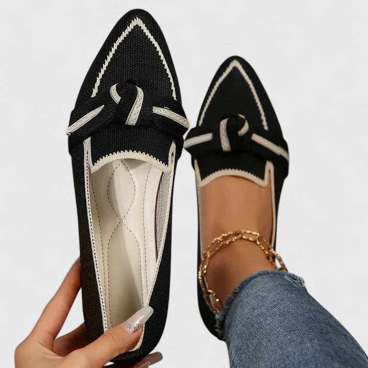 Black pointed toe loafer with cream bow knot and contrasting white topstitching