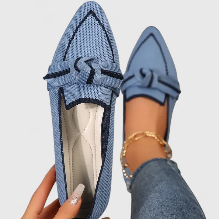 Light blue pointed toe slip-on loafer with black bow knot detail and quilted insole