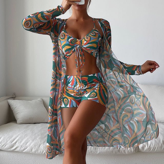Women's three-piece printed crop set with teal and orange abstract pattern, includes crop top, shorts, and sheer cardigan
