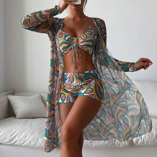 Women's three-piece printed crop set with teal and orange abstract pattern, includes crop top, shorts, and sheer cardigan
