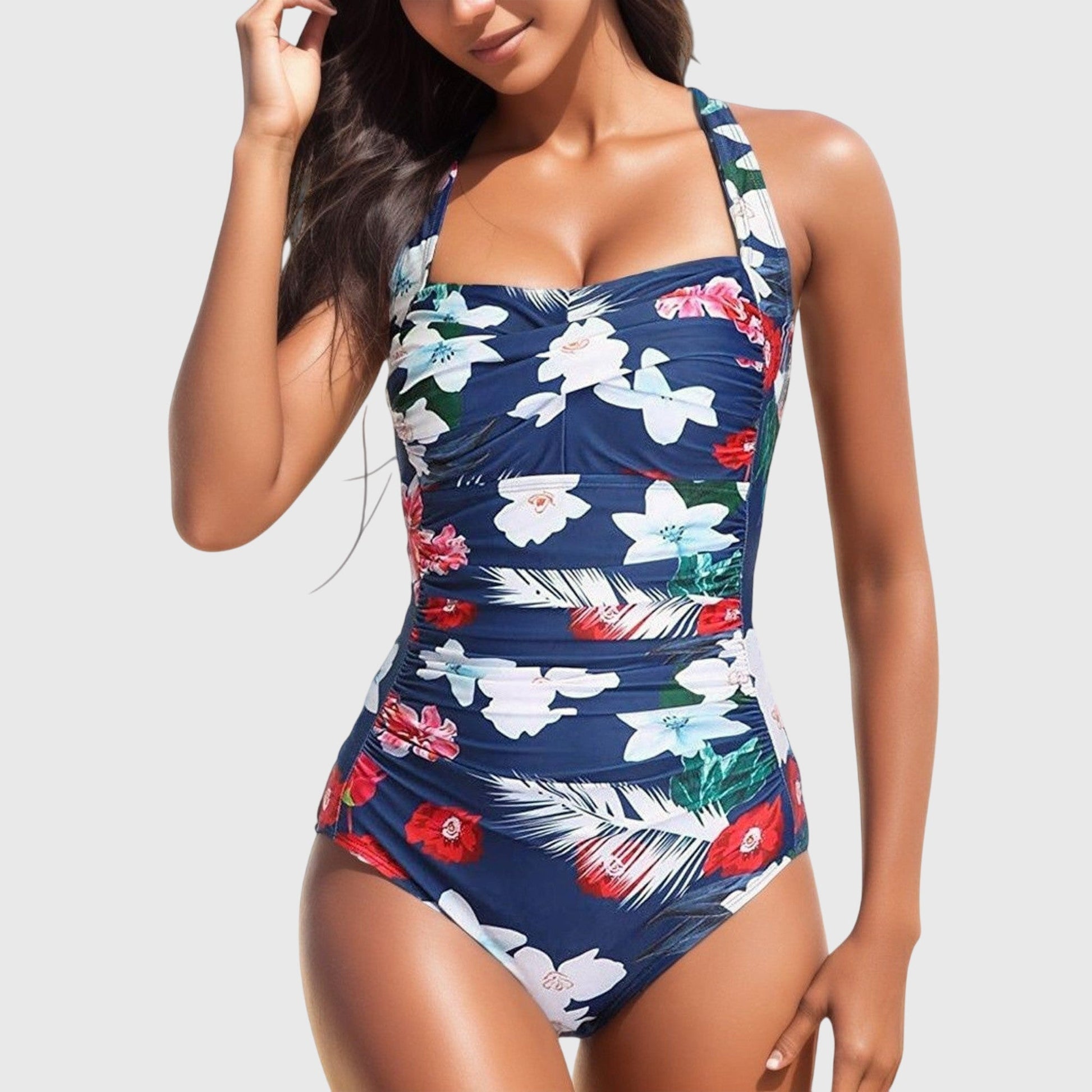 Navy one-piece swimsuit with white and red tropical flowers and ruched details