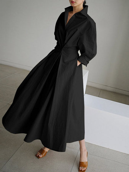 Black wrap midi dress with billowing puffed sleeves and flowing skirt