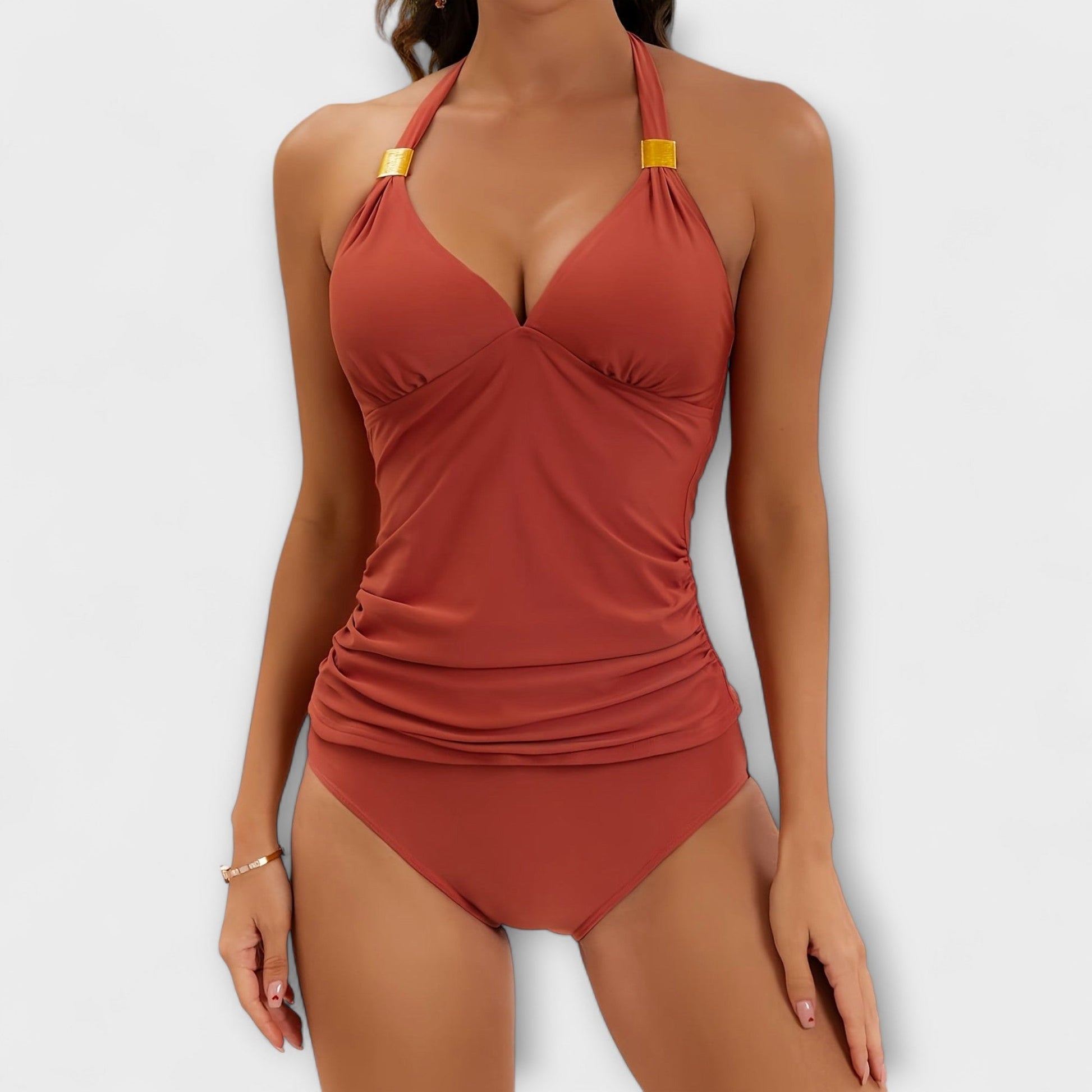 Rust red halter two-piece swimsuit with gold hardware and ruched waist