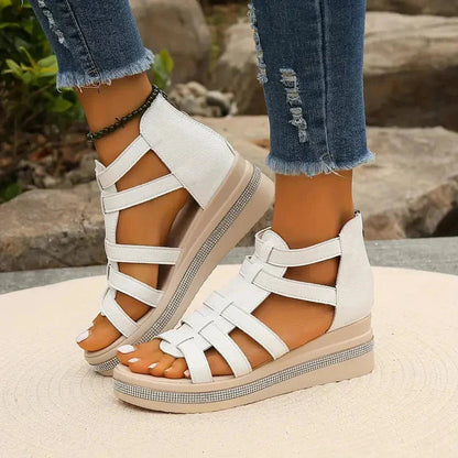 White strappy sandal with rhinestone-embellished platform sole, close-up detail
