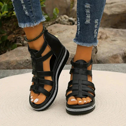 Black strappy platform sandals with rhinestone sole detail and front view of straps