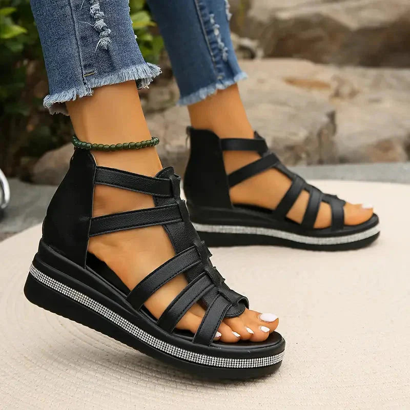 Black strappy platform sandals with rhinestone embellished sole and multiple ankle straps