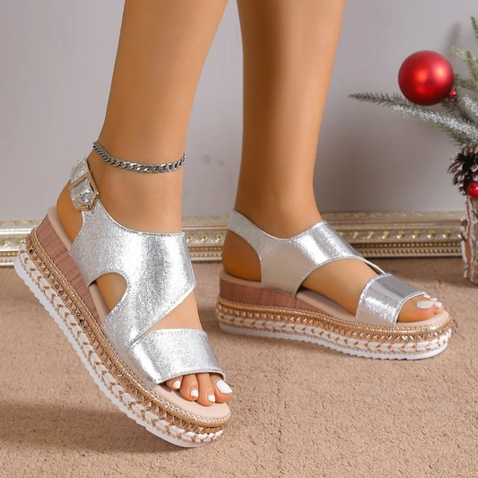 Silver metallic platform sandals with ankle strap and textured sole, front view