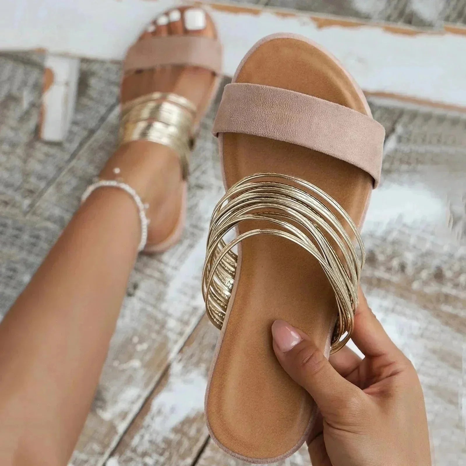 Beige padded slide sandal with metallic gold straps and soft footbed