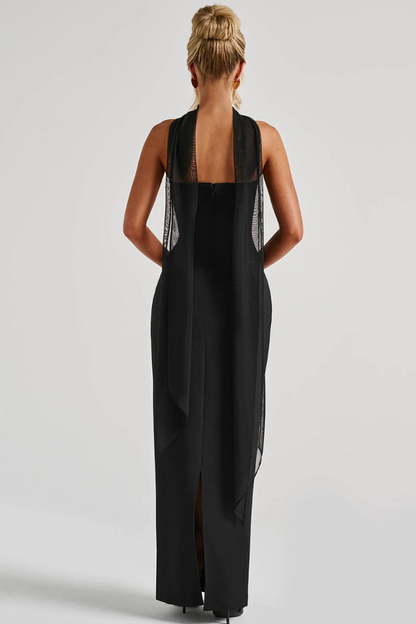 Back view of black strapless maxi dress with sheer scarf draping