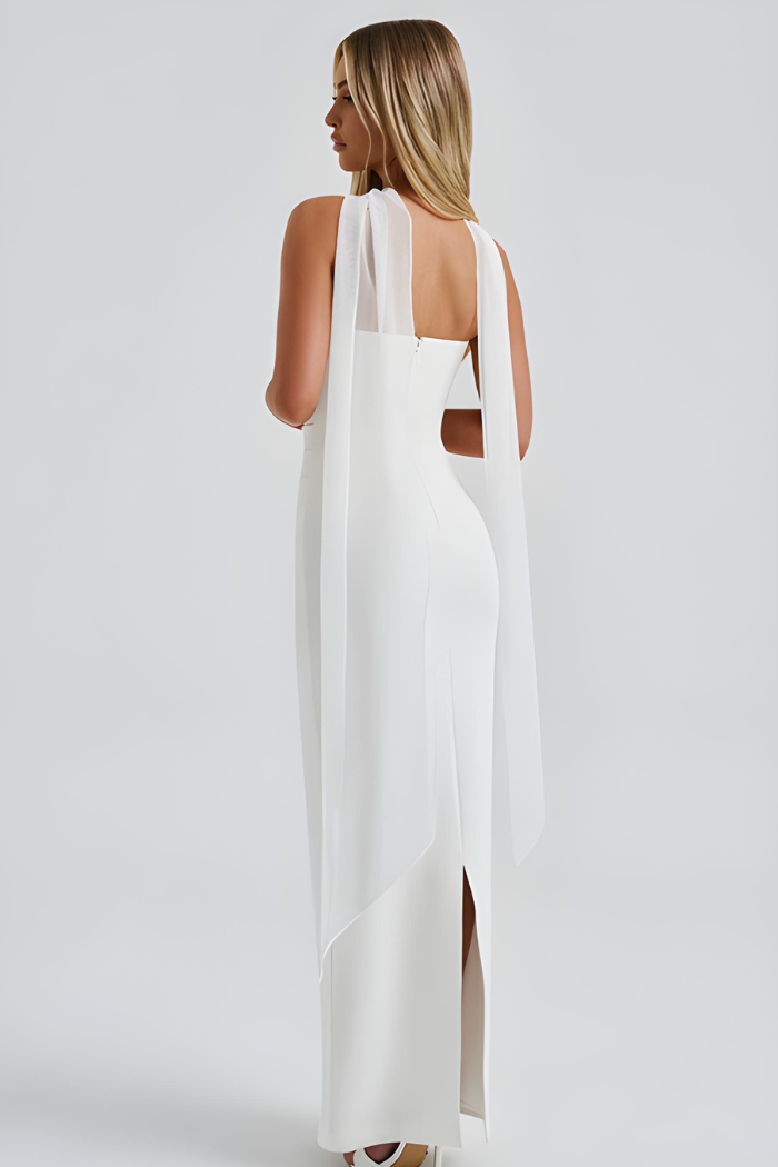 Back view of white strapless bodycon dress with flowing sheer scarf
