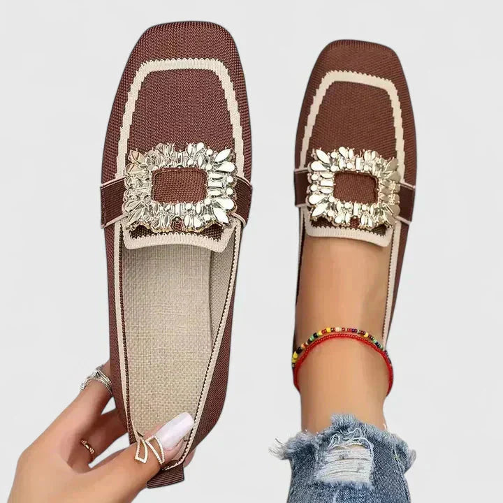 Brown knit loafers with cream ruffled trim and decorative bow detail