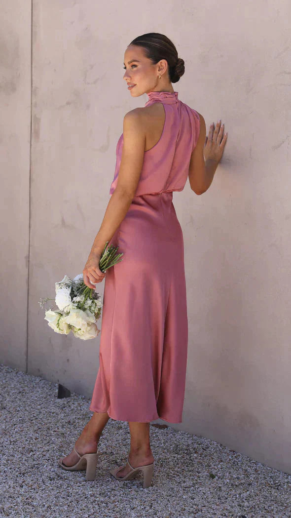 Back view of dusty rose halter dress with open back design