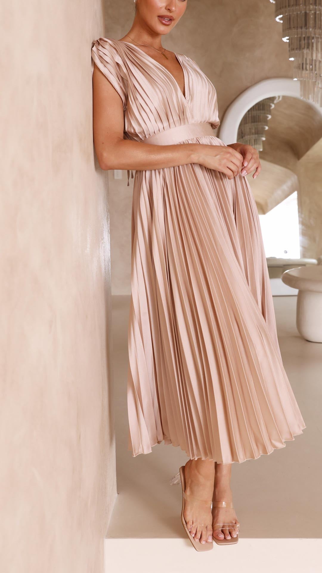 Back view blush pink sleeveless midi dress with pleated bodice and flowing skirt