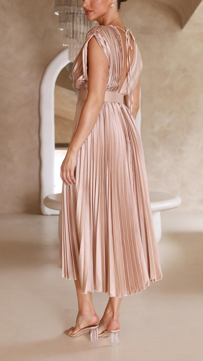 Back view of blush pink pleated midi dress showing open back detail