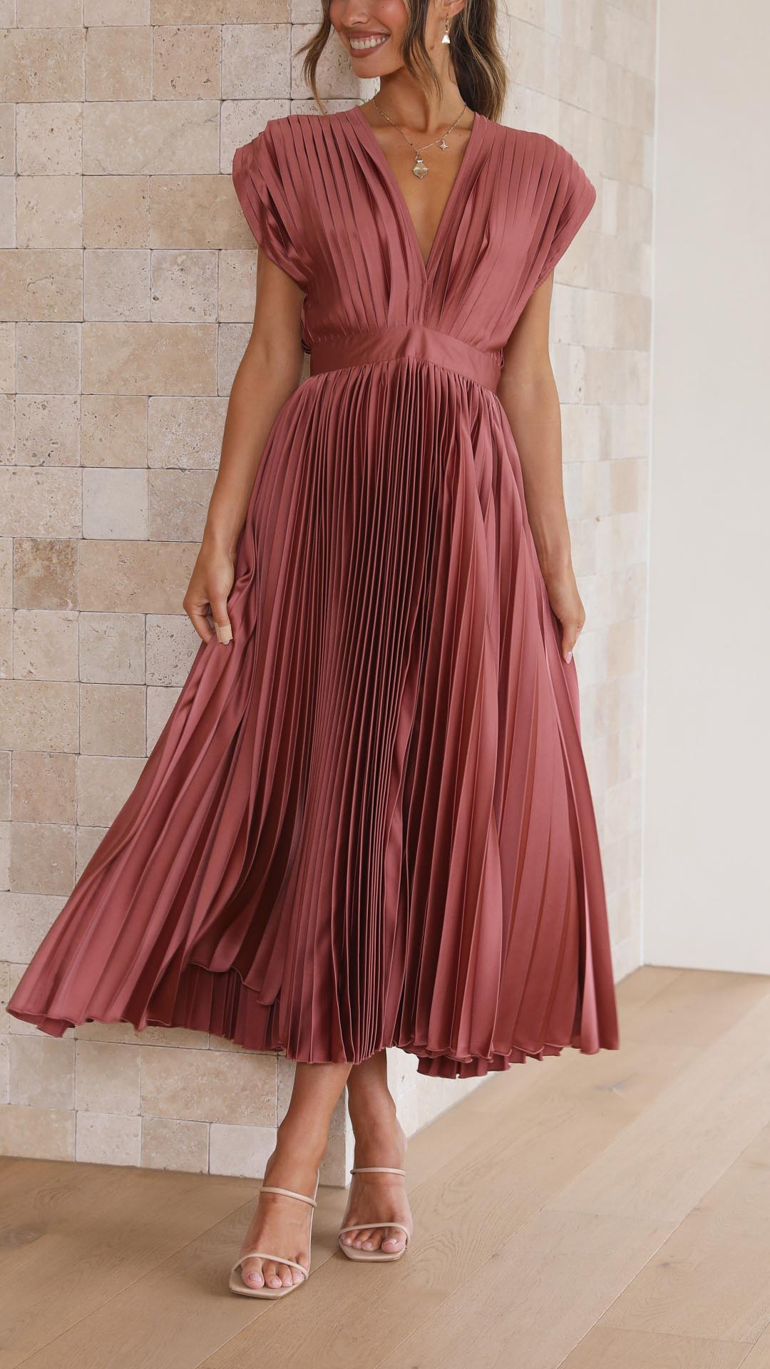 Front facing mauve high waisted midi dress with deep v-neck and pleated bodice