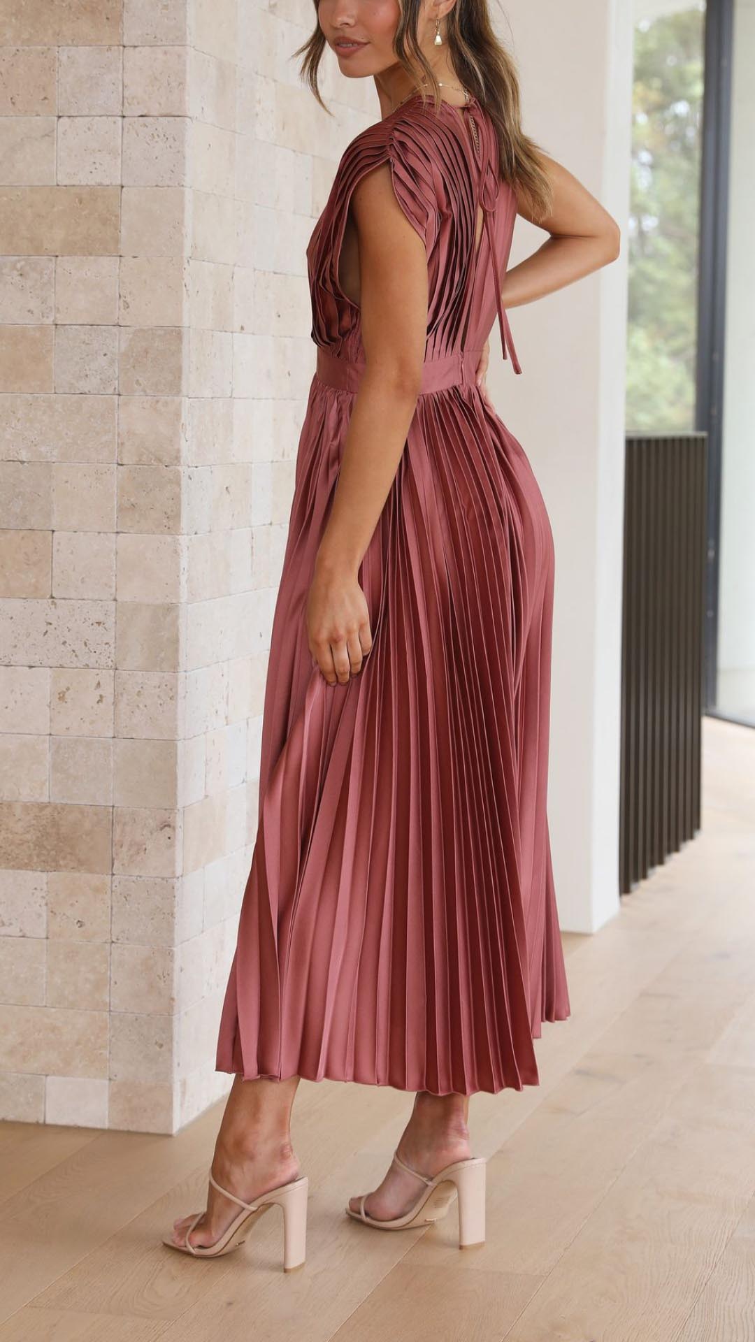 Back view of mauve sleeveless midi dress with open back detail and pleated skirt