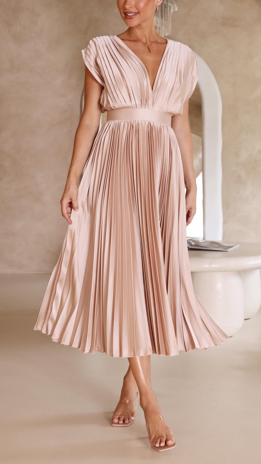 Front view blush pink pleated midi dress with deep v-neckline and cinched waist
