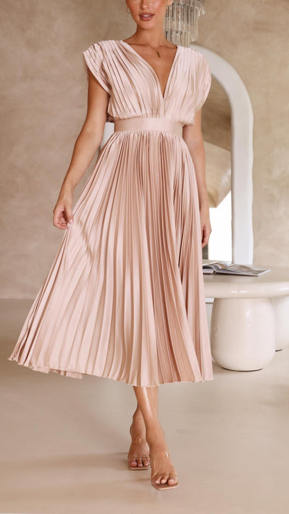 Side profile blush pink high waisted midi dress showing pleated skirt flow