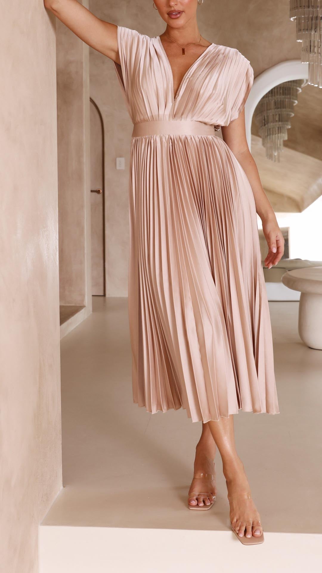 Three-quarter view blush pink pleated midi dress with v-neck and high waistline
