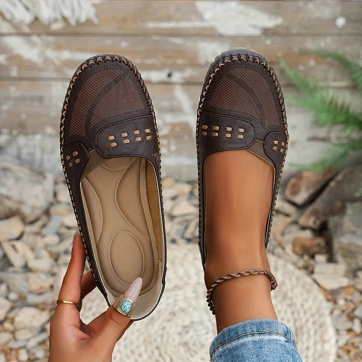 Dark brown perforated loafer flat with cushioned arch support and whipstitched edge