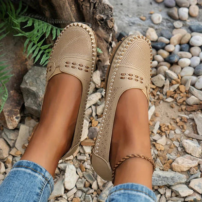 Beige loafer flat with arch support worn on gravel showing top-down view and comfort design