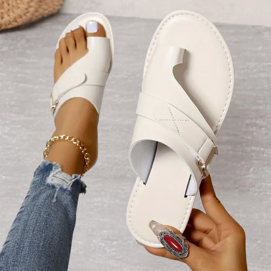 Cream orthopedic cross strap sandal with open toe and adjustable buckle closure