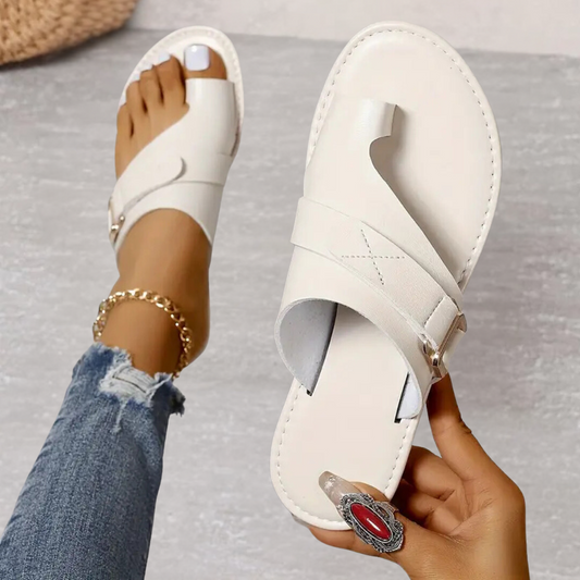 Cream orthopedic cross strap sandal with open toe and adjustable buckle closure