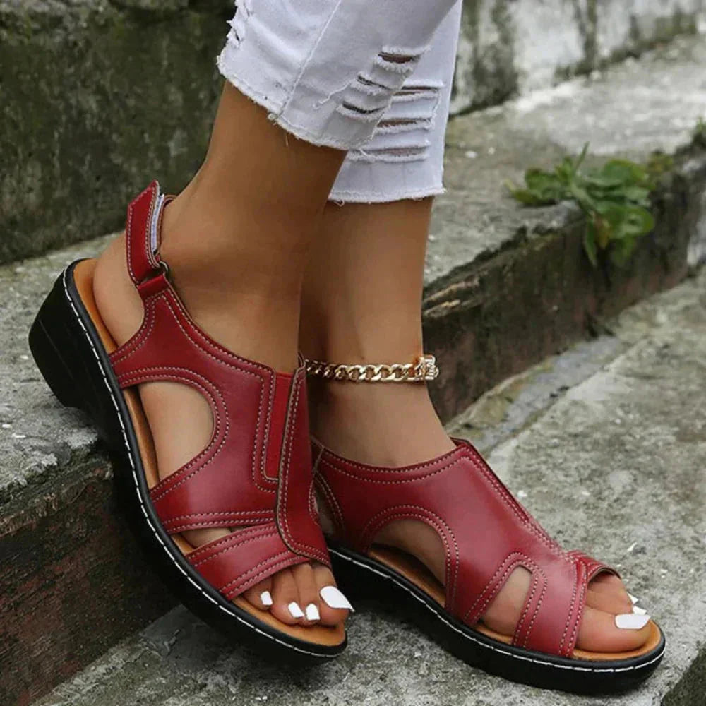 Burgundy red leather adjustable cut-out strappy sandal with black sole and gold chain ankle bracelet