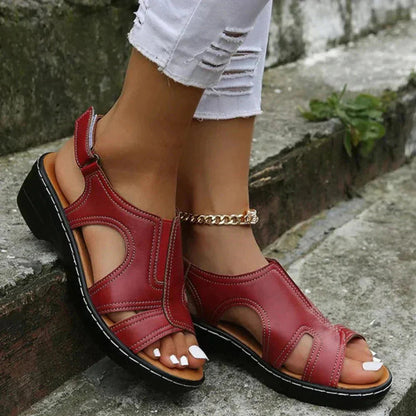 Burgundy red leather adjustable cut-out strappy sandal with black sole and gold chain ankle bracelet