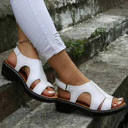 White leather adjustable cut-out strappy sandal with black sole and brown inner lining