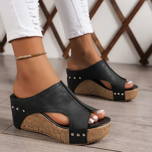 Black studded cork wedge platform sandals with peep toe and cutout detail