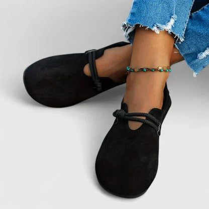 Black suede orthopedic rope loafer worn on foot with rope detail visible